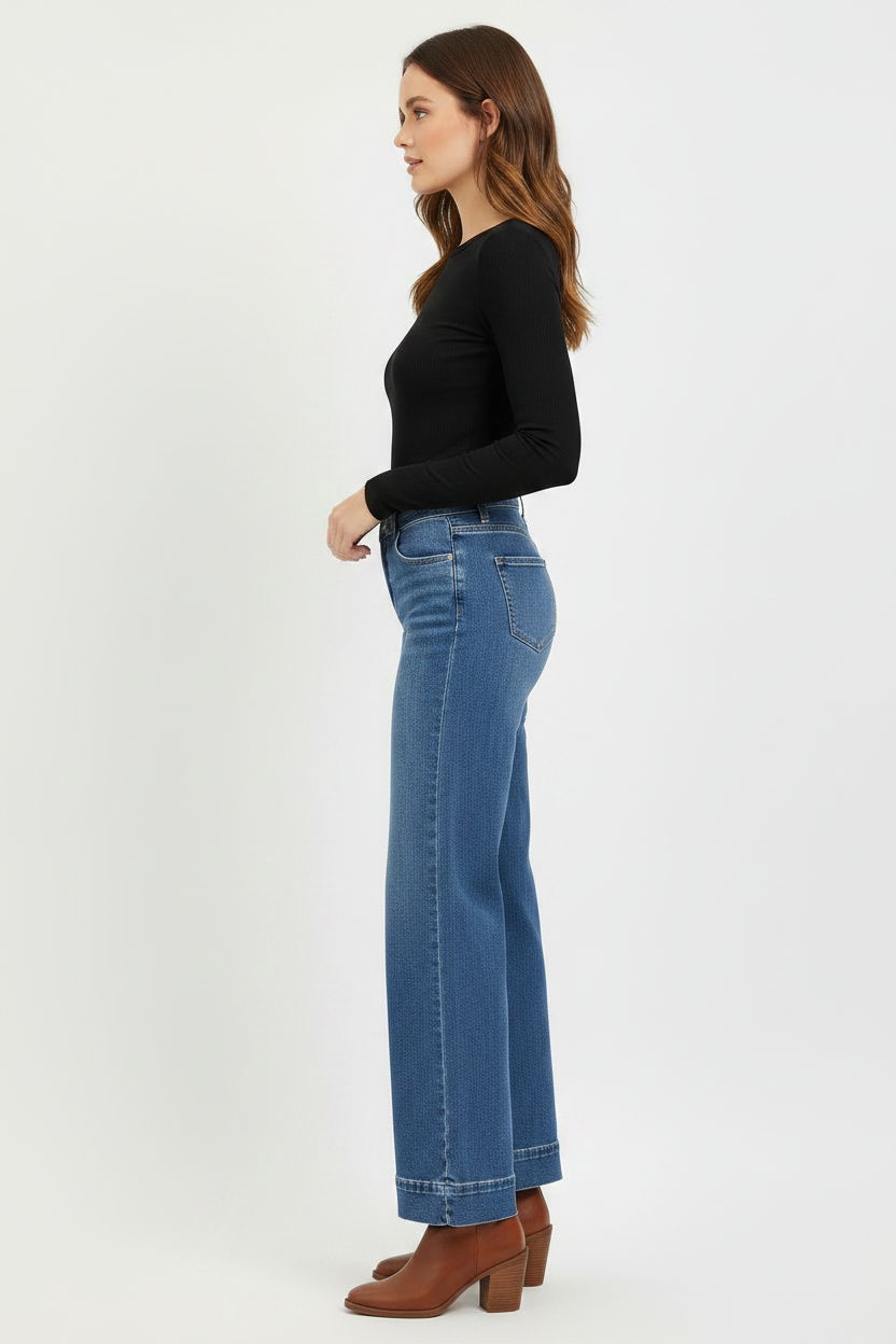 Wide leg jeans side view styled with black shirt and brown leather boots